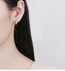 Close-up of 925 sterling silver infinity earrings with sparkling zircon stones