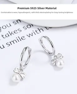 Detailed view of S925 silver hoop earrings with elegant butterfly bow and white pearl drops