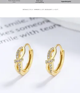 Detailed view of 925 sterling silver bow earrings with gold plating and cubic zirconia
