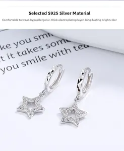 Detail of S925 sterling silver hoop earrings featuring star charms with pavé crystals