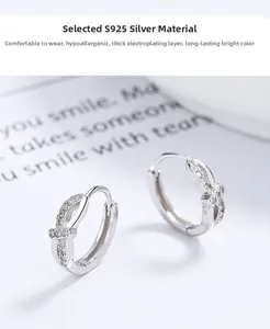 Macro detail of S925 sterling silver twist hoop earrings with pavé cubic zirconia