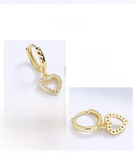 Macro shot of 925 sterling silver heart hoop earrings with S925 hallmark and cubic zirconia