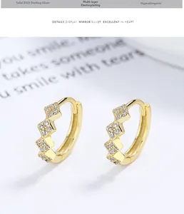 Macro detail of gold S925 sterling silver hoop earrings with pavé set zircon stones