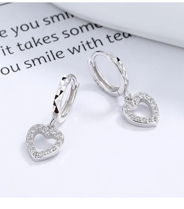 Detail of 925 sterling silver heart hoop earrings with sparkling cubic zirconia stones
