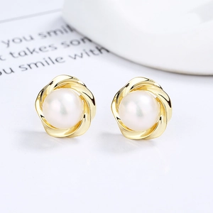 Elegant 925 silver flower pearl stud earrings in gold wire finish on a minimalist background