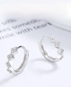 Detailed close-up of 925 sterling silver hoop earrings with three wavy zircon stones