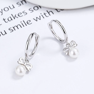 Elegant 925 sterling silver butterfly bow earrings with lustrous round white pearls