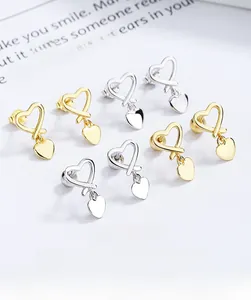 Detailed view of 925 sterling silver heart earrings in gold and silver finishes
