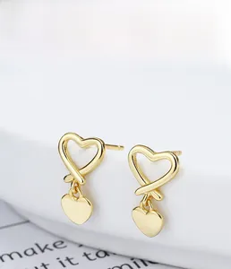 Detail of S925 sterling silver heart earrings with gold plating and allergy-free finish