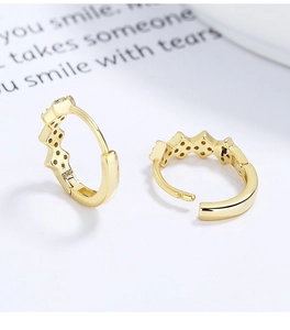 Detailed view of S925 silver wavy gold earrings with micro-pave cubic zirconia crystals