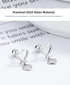 Detailed macro view of S925 sterling silver hollow heart stud earrings with a polished finish