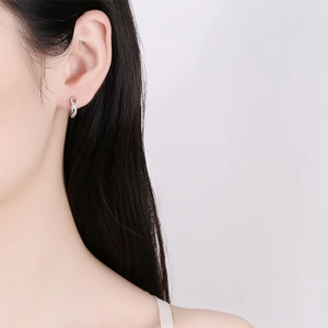 925 sterling silver twisted hoop earrings with sparkling cubic zirconia on female model
