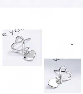 Detail view of 925 sterling silver heart earrings with hollow and solid heart charms