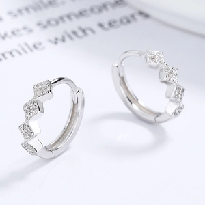 Elegant 925 sterling silver wave hoop earrings with pavé cubic zirconia on white background