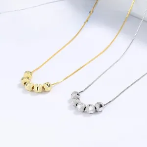 Close-up of 925 silver Mobius double ring necklace in gold and silver finishes
