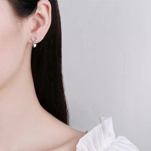 Elegant 925 sterling silver heart earrings worn by model for a minimalist fashion look