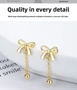 Close-up of gold-plated S925 silver bow tassel earrings with polished metallic texture