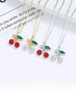 Detailed macro of 925 silver cherry pendants with red and white pave cubic zirconia