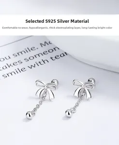 Detailed macro view of S925 sterling silver bow tassel earrings with polished bead finish
