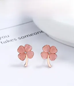 Macro view of pink cat eye stone clover earrings in S925 sterling silver and rose gold