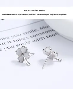 Macro detail of S925 sterling silver four-leaf clover stud earrings with opal texture