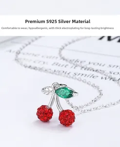 Macro shot of S925 silver cherry pendant necklace with red and green zircon stones