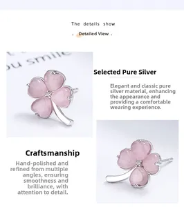 Macro detail of 925 sterling silver four-leaf clover earrings with pink stones