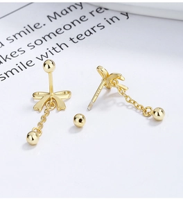 Detailed macro view of S925 sterling silver stamp and screw back on bow tassel earrings