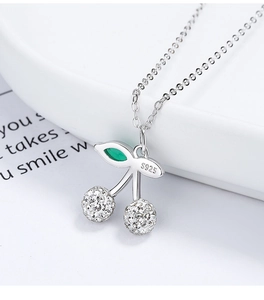 Macro shot of silver cherry pendant showing the S925 hallmark and crystal pave setting