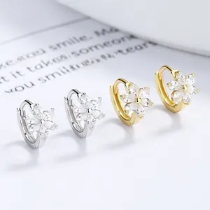 Detailed view of 925 silver and gold tulip hoop earrings with cubic zirconia petals