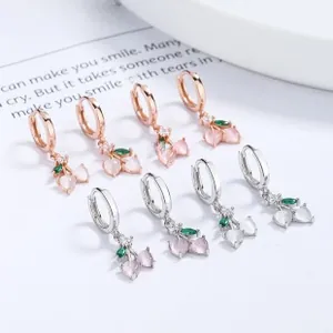 Detail view of 925 silver cherry hoop earrings with pink gemstones in rose gold and silver