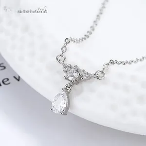 Macro shot of 925 silver koi necklace featuring a pear-cut drop stone and cross chain
