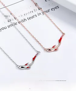 Detail of 925 sterling silver koi necklace featuring enamel finish and pavé diamonds