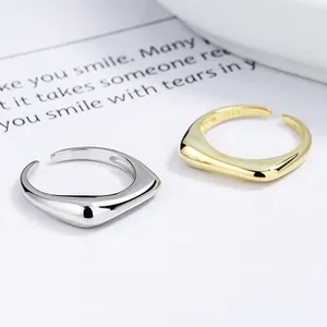 Detail of silver and gold S925 sterling silver open rings with engraved hallmark