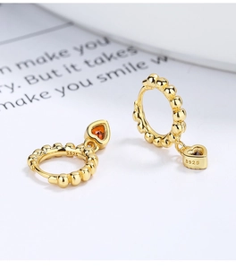 Detail of 925 sterling silver heart earring with orange gem and S925 hallmark stamp