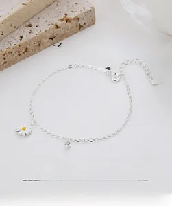 Macro shot of 925 sterling silver daisy bracelet with heart tag and extension chain