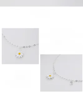 Detailed macro view of S925 sterling silver daisy charm bracelet with white enamel petals