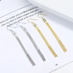 Macro view of long sterling silver tassel earrings with delicate chain fringe detail