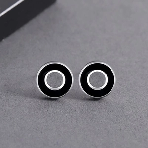 Trendy silver and black round stud earrings featuring a triple concentric circle design