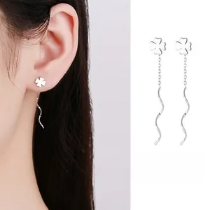 Detail of 925 sterling silver four-leaf clover long threader earrings with wave design