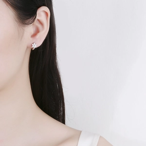 Boucles d'oreilles fleurs en argent sterling 925 avec zircons portées par un modèle