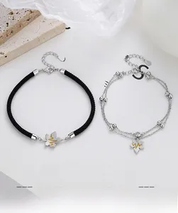 Detailed view of S925 sterling silver couple bracelets with leaf pendants and heartbeats