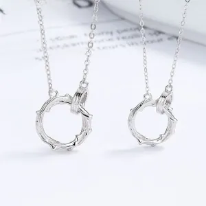 Macro shot of 925 sterling silver couple necklaces with interlocking textured rings
