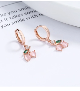 Macro detail of S925 sterling silver cherry earrings with pink cat eye stones