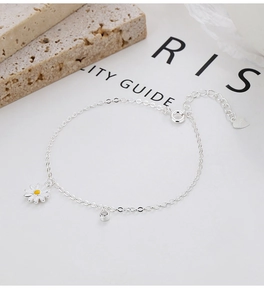 Macro detail of S925 sterling silver daisy bracelet with zircon and hallmarked charm