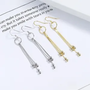 Detailed close-up of 925 sterling silver long fringe tassel earrings in gold and silver
