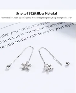 Detail of 925 sterling silver flower earrings with zircon pavé and tassel ear wire