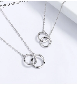 Detail view of 925 silver Mobius double ring necklaces with polished finish and pavé zircon
