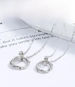 Detail of S925 sterling silver couple necklaces with textured vine ring and plating