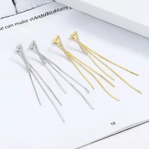Macro shot of 925 sterling silver long tassel earrings with sparkling zircon knot detail